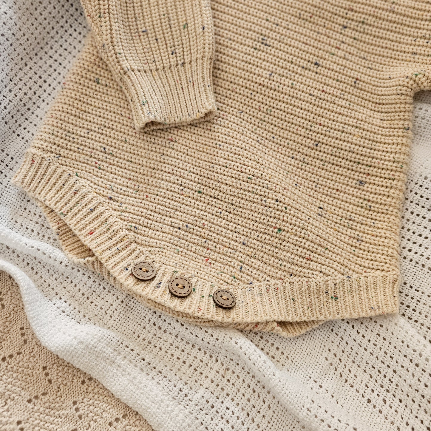 Speckled Sand cotton newborn romper, soft knitted baby outfit for 0–3 months by Harper Clare.