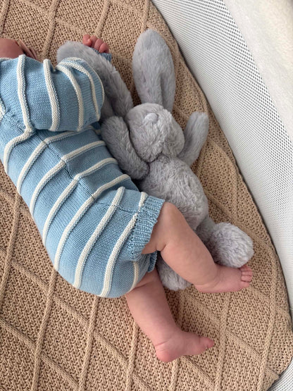 Sky blue and white newborn knitted romper close-up