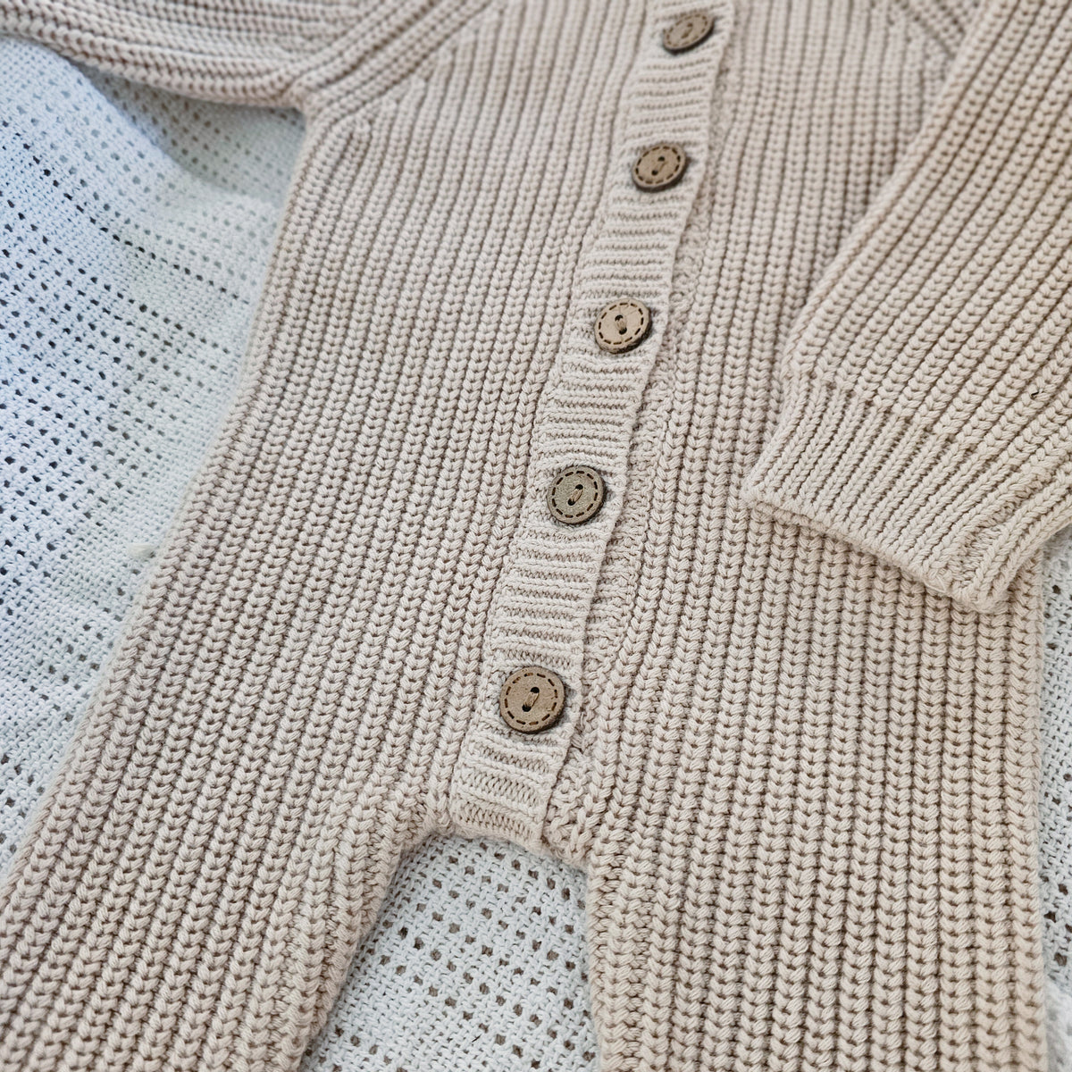 Earthy taupe chunky knit baby bodysuit with wooden buttons, newborn size
