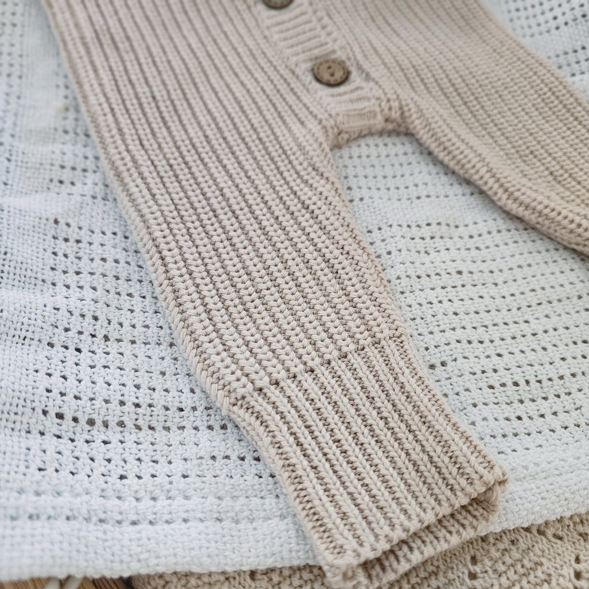 Earthy taupe chunky knit baby bodysuit with wooden buttons, newborn size