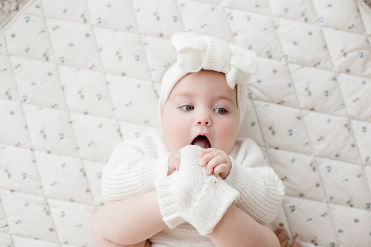Milk White organic cotton newborn booties, soft knitted baby booties for 0–3 months by Harper Clare.
