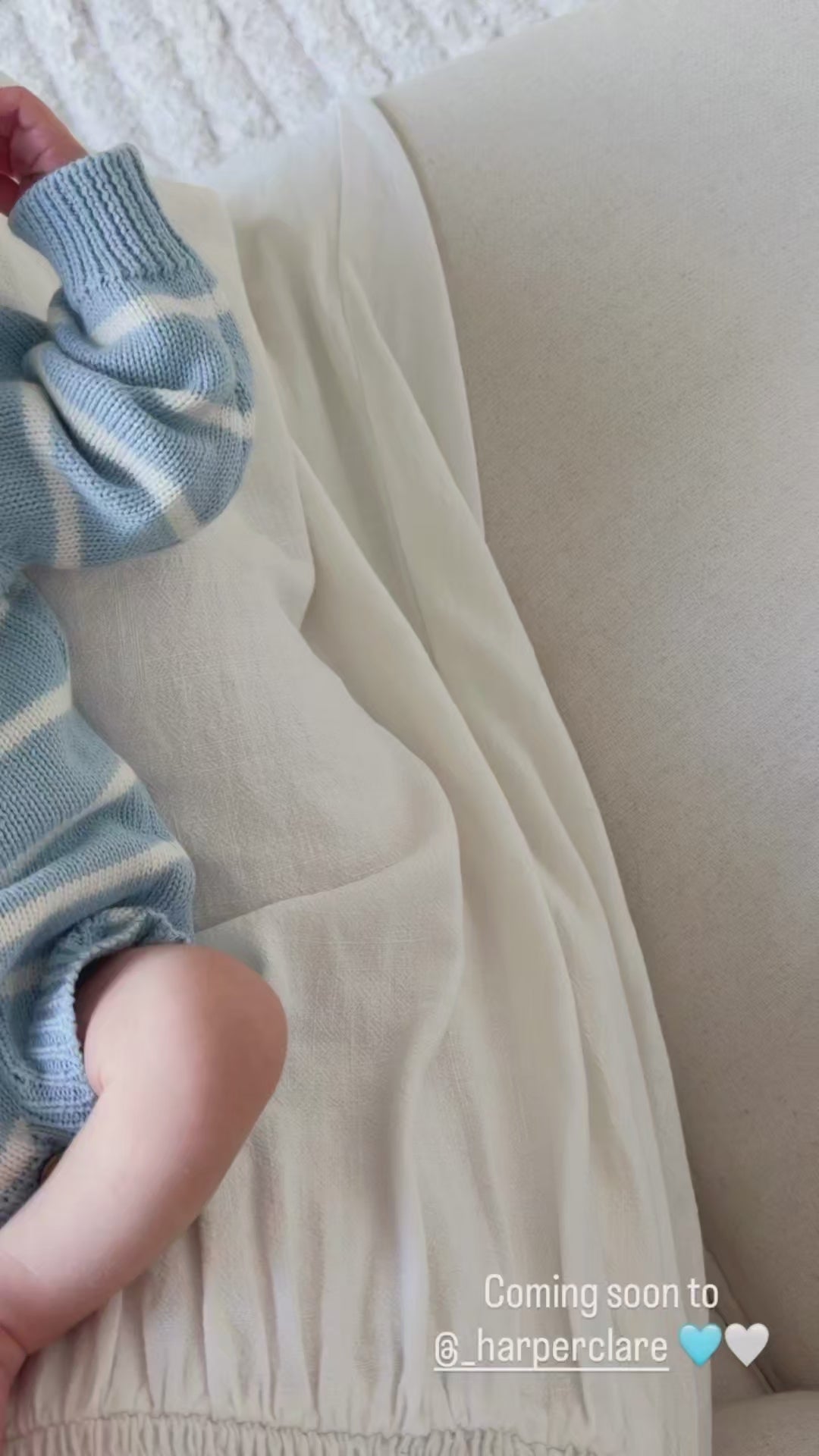Load video: Sky blue ribbed knitted baby romper in a soft stretch knit, featuring a classic one-piece design and textured ribbed detailing.