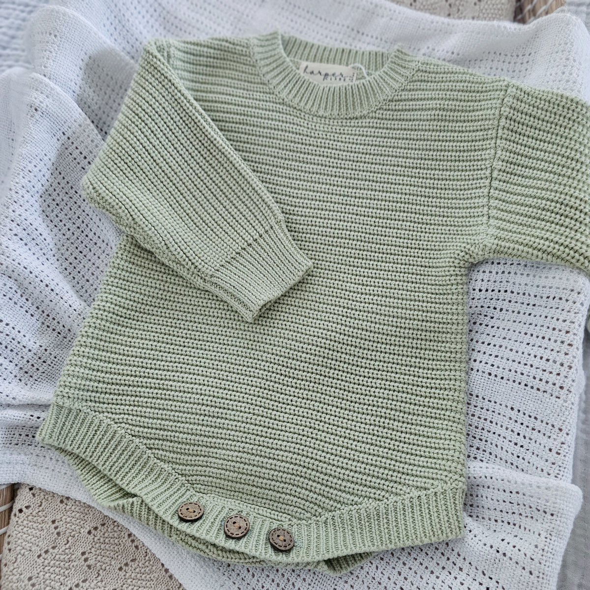 Tea Green organic cotton newborn romper, soft knitted baby outfit for 0–3 months by Harper Clare.