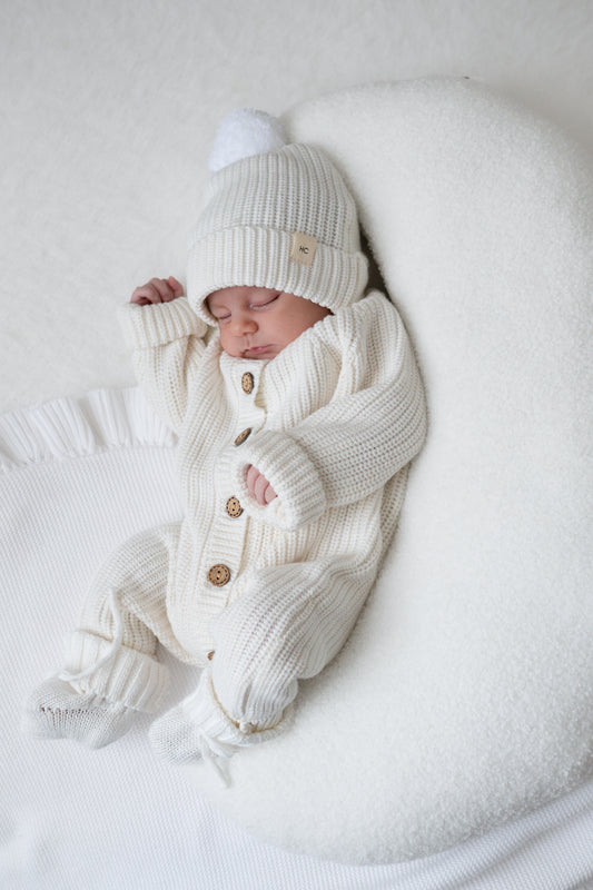 white newborn baby romper knitted with matching booties and beanie