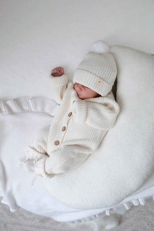 white newborn baby romper knitted with matching booties and beanie